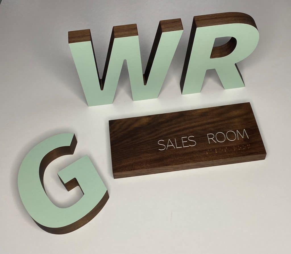 Walnut wood dimensional letters and ADA signs