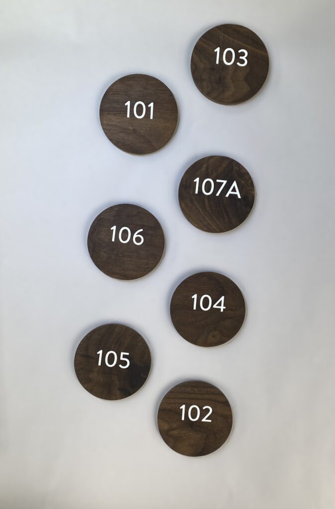 circle cut walnut wood with room numbers